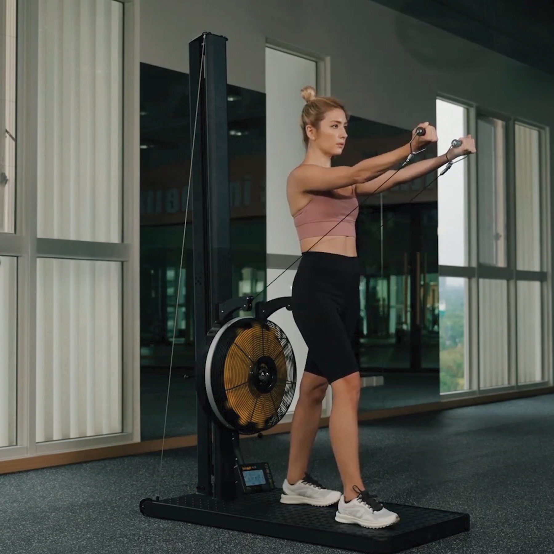 Person exercising on ski machine heavy duty, commercial grade like Hyrox Training down position 3 position adjustable